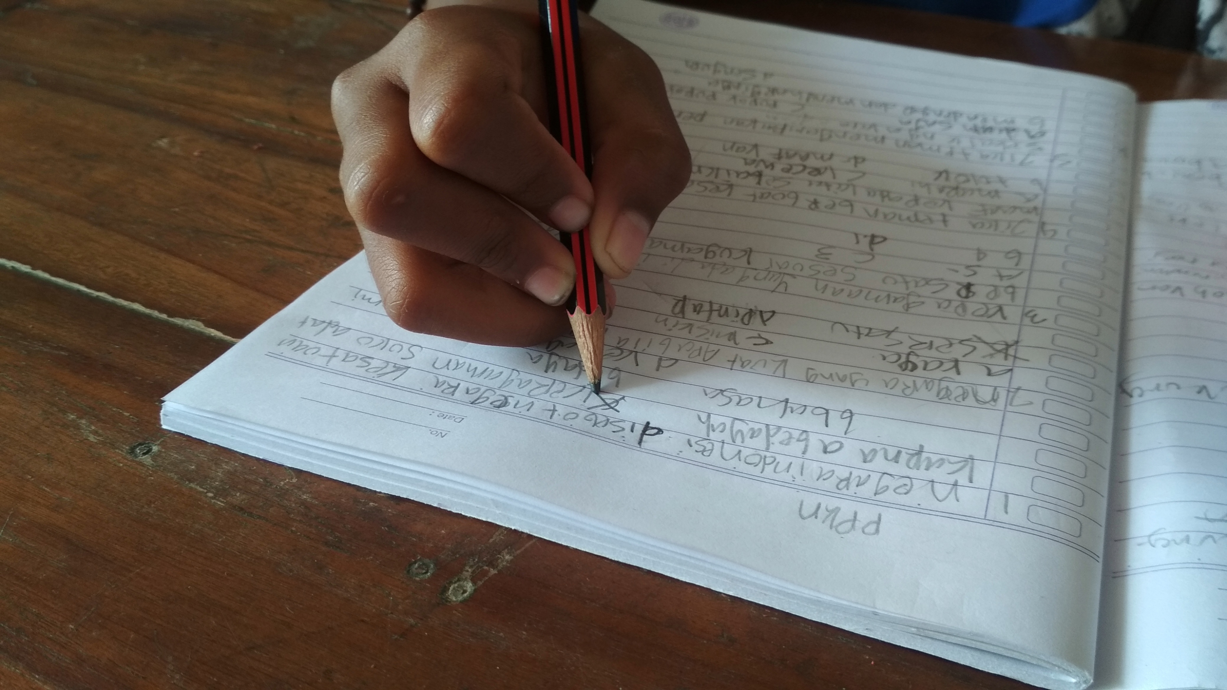Child writing in schoolbook
